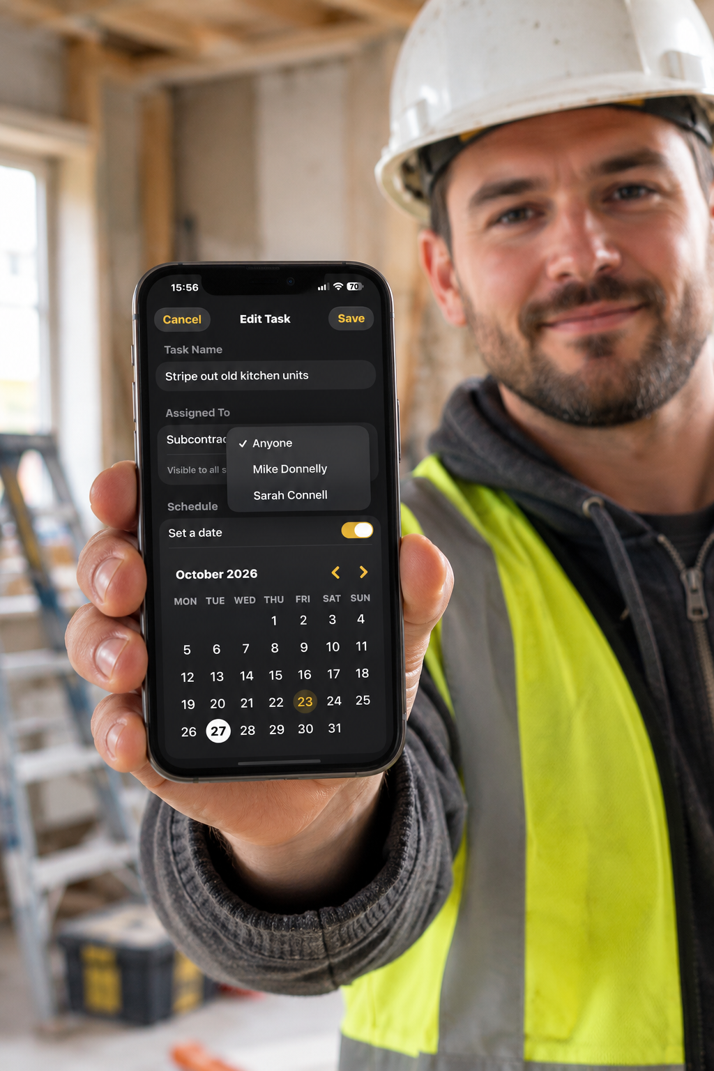 Builder on site using RenovateIQ Business to assign tasks to subcontractors